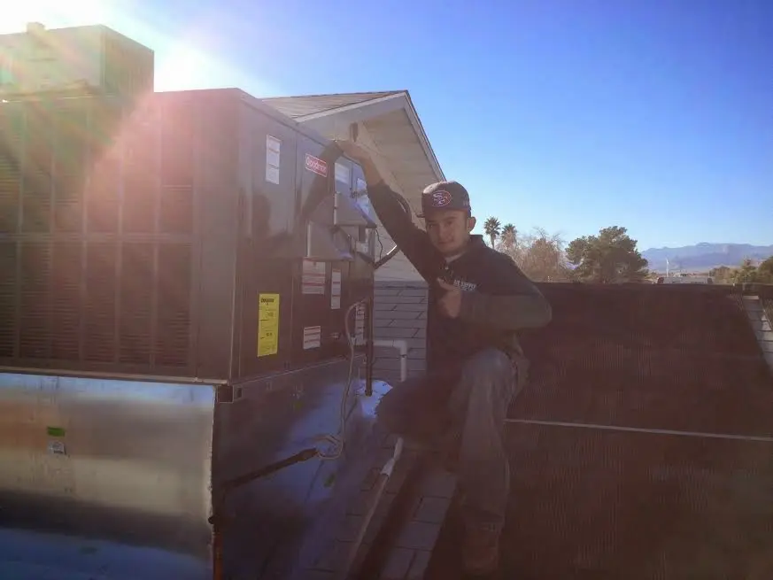 HVAC technician performing AC Tune-Up on a rooftop unit in Castro Valley
